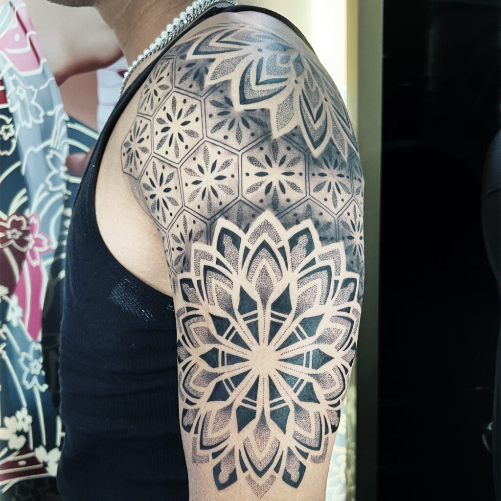a mandala and geometric tattoo